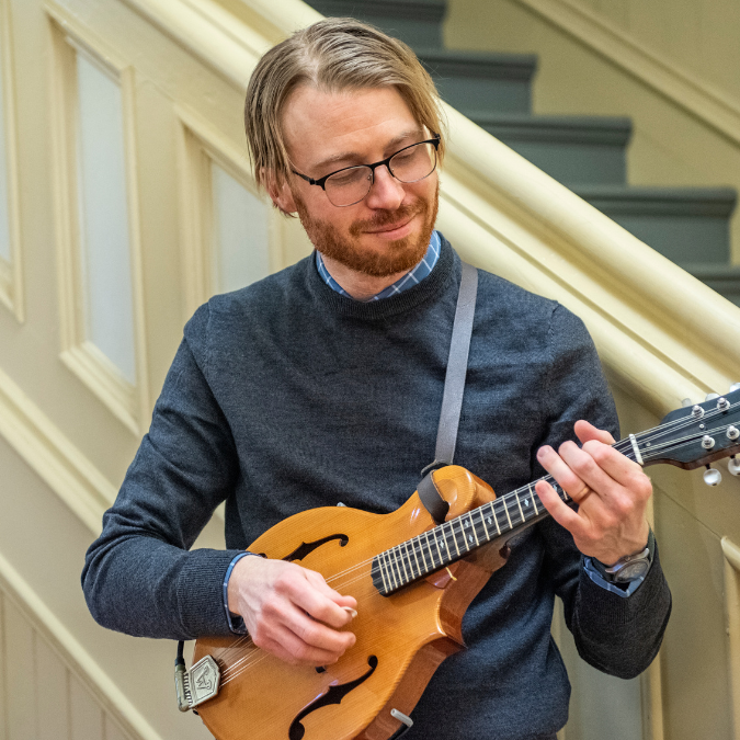 person playing mandolin