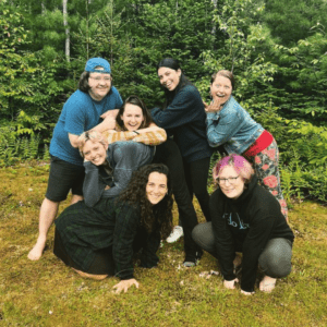 Group of people in grass smiling