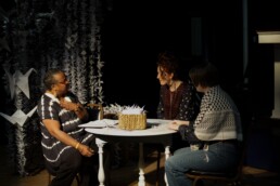 Three performers sitting