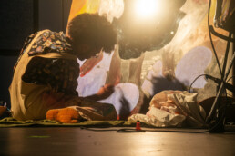 artist panting seated on the floor